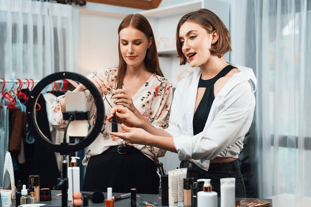 Woman influencer shoot live streaming vlog video review makeup utmost social media or blog. Happy young girl with cosmetics studio lighting for marketing recording session broadcasting online. - 写真・画像