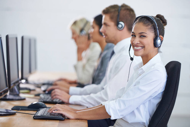 Callcenter, portrait and phone call with woman, typing on computer and consultant at customer support. Headset, telemarketing and client service agent at help desk with teamwork in coworking space. - Photo, Image