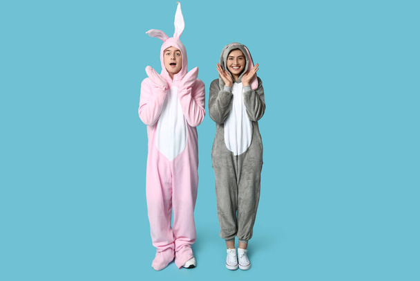 Mavi arka planda tavşan kostümlü güzel bir çift. Paskalya kutlaması - Fotoğraf, Görsel
