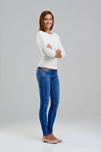 Portrait, confidence and happy woman in studio for fashion isolated on a white background mockup space. Arms crossed, young person and student in casual clothes, jeans or trendy style in Argentina. - Photo, Image