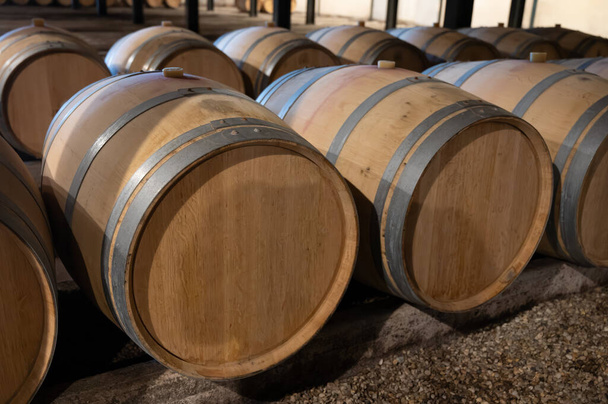 WIne κελάρι με γαλλικά δρύινα βαρέλια για τη γήρανση του κόκκινου κρασιού από Cabernet Sauvignon ποικιλία σταφυλιών, Haut-Medoc αμπελώνες στο Μπορντό, αριστερή όχθη του εκβολών Gironde, Pauillac, Γαλλία - Φωτογραφία, εικόνα