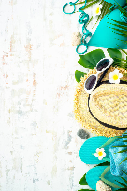 Summer flat lay background. Palm leaves, hat, flip flop and sunglasses on white background. - Photo, Image