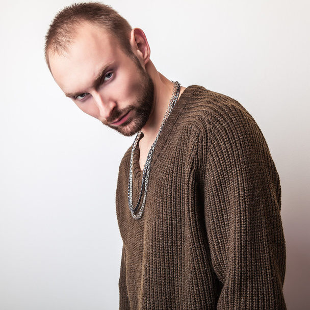Studio portrait of young handsome man in casual knitted sweater. Close-up photo. - Fotó, kép