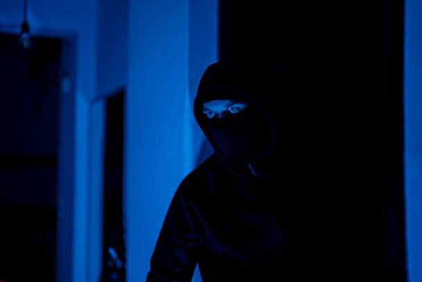 Masked robber checking the apartment. - Photo, Image