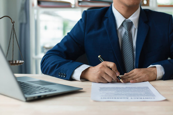 contract was placed on table inside legal counsel's office, ready for investors to sign the contract to hire a team of lawyers to provide legal advice for their investment. legal consulting concept - Photo, Image