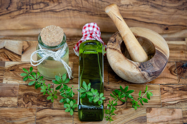green Woodruff vinegar on olive wood - Photo, Image