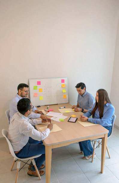 group of people sitting around a table with sticky notes - Photo, Image