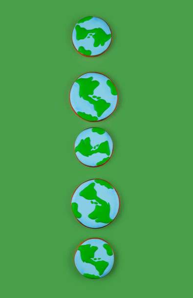 Concepto del Día de la Tierra. Galleta en forma de Tierra en mano. - Foto, imagen
