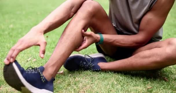 Runner, park and massage with leg, pain and cardio for exercise and health. Person, training and calf with injury, muscle and sneakers for marathon performance with fatigue and wellness or fitness. - Footage, Video