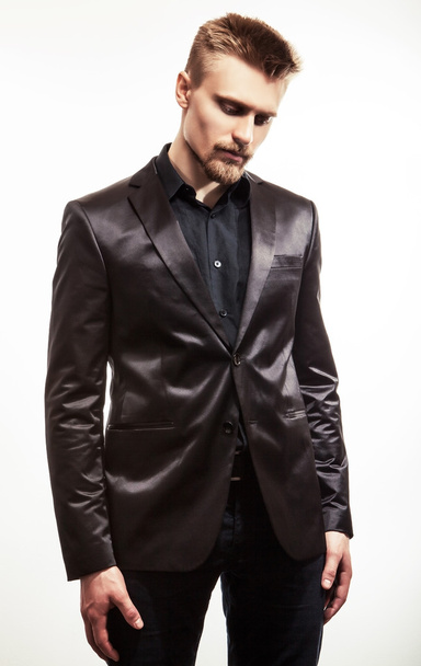 Elegant young handsome man in black costume. Studio fashion portrait. - Φωτογραφία, εικόνα