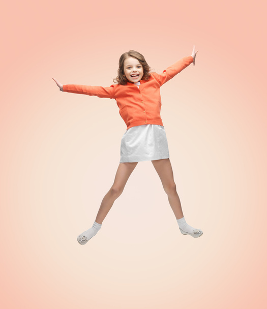 happy girl in casual clothes jumping high - Фото, изображение