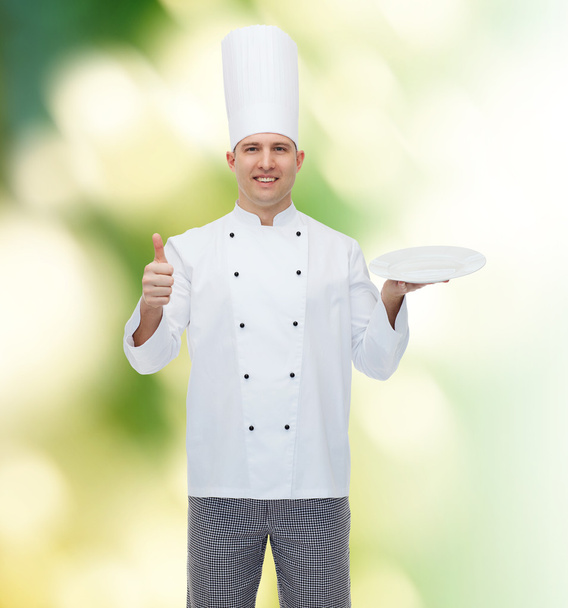 happy male chef cook showing thumbs up and plate - Photo, Image