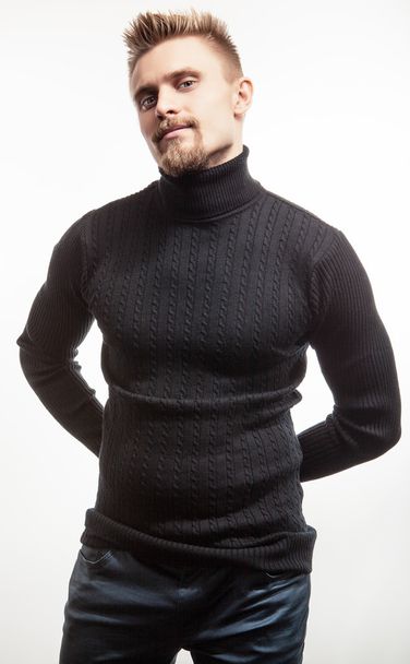 Studio portrait of young handsome man in knitted sweater. Close-up photo. - Foto, Bild