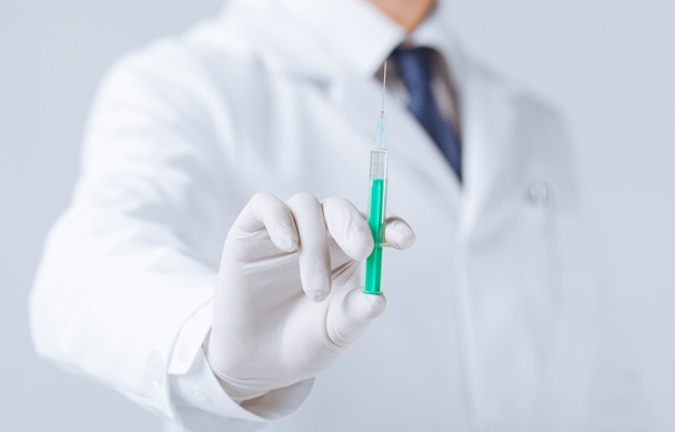 male doctor holding syringe with injection - Photo, Image