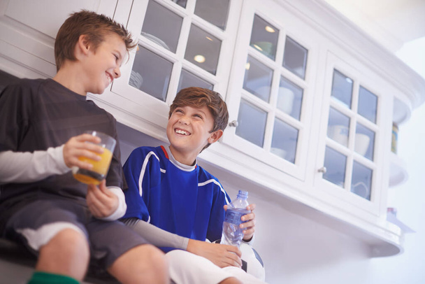 Kitchen, team and boys with smile for drinks, soccer or football and practice for match with ball. Friends, children and kids ready in house for workout, exercise and training to play sport for game. - Photo, Image