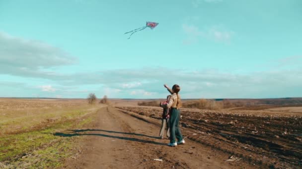 Caucasian boys flying a kite. Children playing in nature with a kite. Two brothers run a kite. - Felvétel, videó