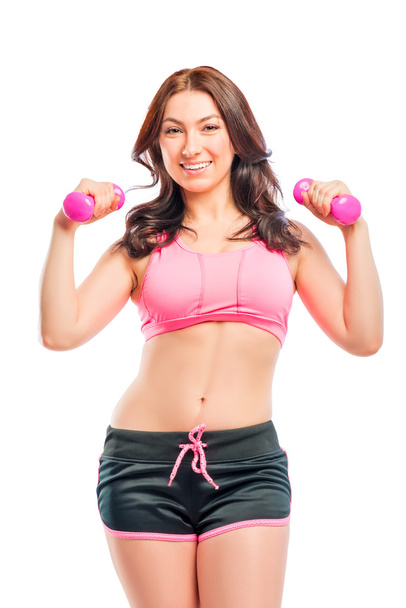 portrait of a beautiful trainer with dumbbells on a white backgr - Foto, Imagen