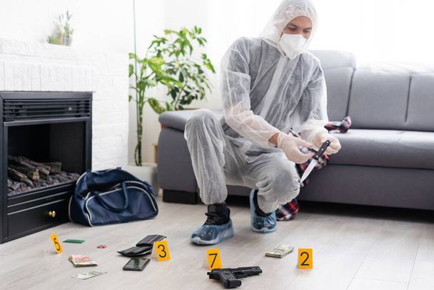 Detective Collecting Evidence in a Crime Scene. Forensic Specialists Making Expertise at Home of a Dead Person. Homicide Investigation by Professional Police Officer. High quality photo - Photo, Image