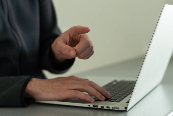 Businessman closeup finger point at laptop display on desk, hand typing on keyboard, blurred background. Concept of online shopping, offer and recommend - Photo, Image