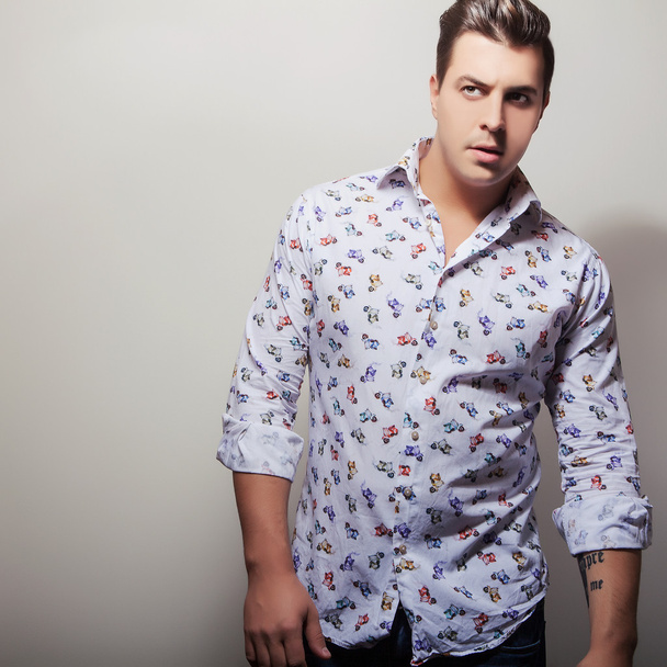 Elegant young handsome man in bright colorful shirt. Studio fashion portrait. - Photo, Image