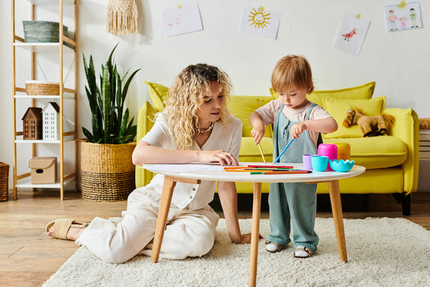 A curly mother and her toddler daughter engage in play using Montessori toys at home, fostering curiosity and learning. - Photo, Image