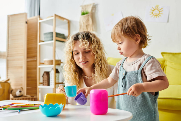 A curly-haired mother and her toddler daughter are immersed in playtime, utilizing Montessori educational toys at home. - Photo, Image