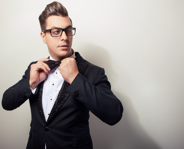 Elegant young handsome man in black luxury costume. Studio fashion portrait. - Foto, afbeelding