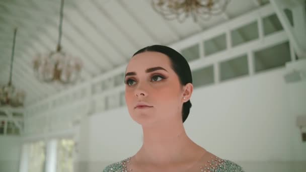 Porträt einer jungen Frau mit elegantem Make-up in einem luxuriösen Interieur, das bei Tageslicht Raffinesse und Besinnlichkeit ausstrahlt - Filmmaterial, Video