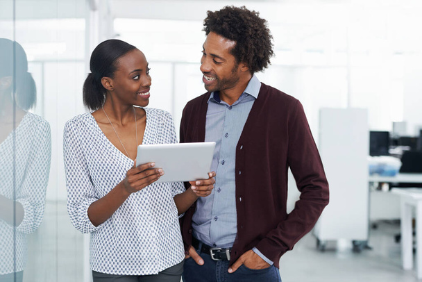 Smile, tablet and teamwork with business people in office together for project management. Collaboration, research or technology with young black man and woman employee in workplace for discussion. - Photo, Image