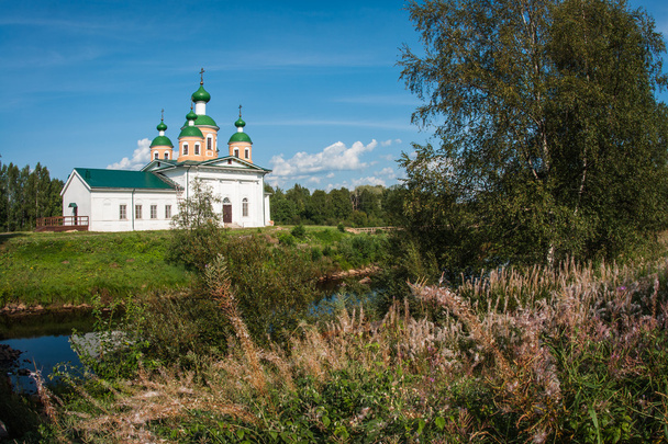 White church on the bank of the river - Фото, изображение