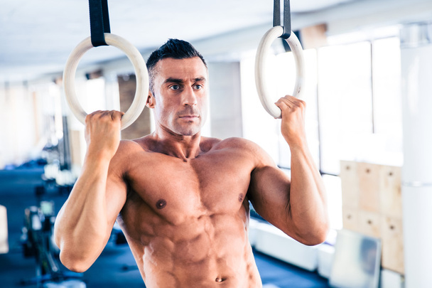 Muscular man workout on fitness ring - Valokuva, kuva