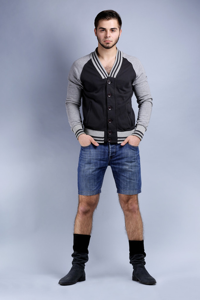 Man in casual style on gray background - Foto, Imagem