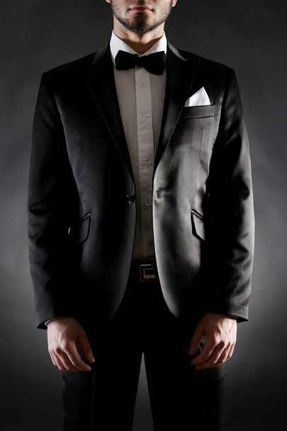 Elegant man in suit on dark background - Valokuva, kuva
