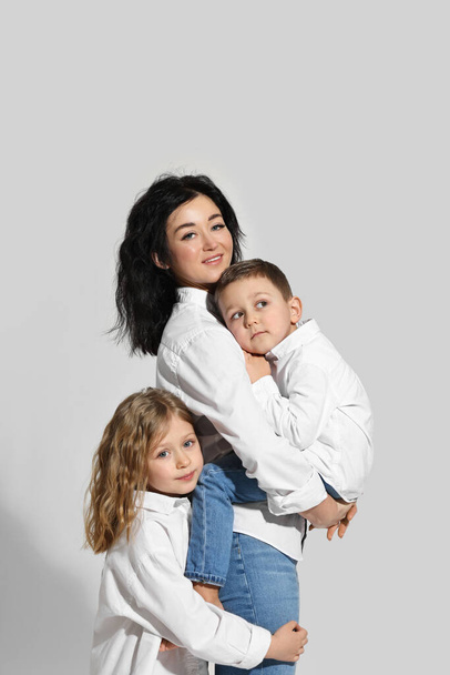 Little children with their mother on white background - Φωτογραφία, εικόνα