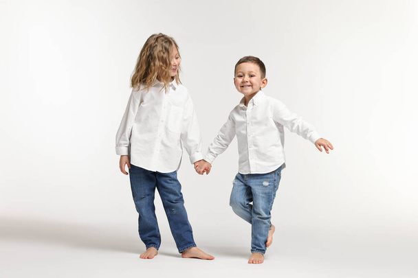 Cute little children on white background. Happy family - Фото, изображение