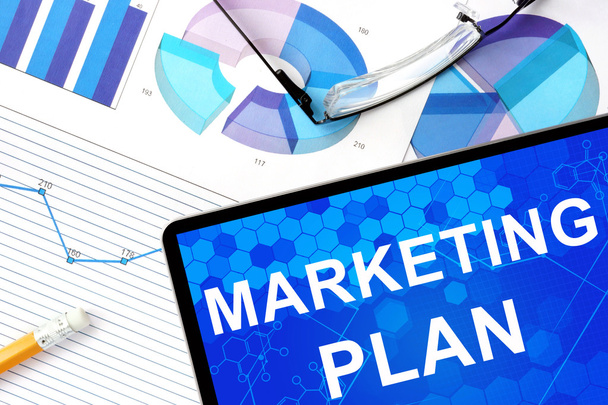 Tablet with  marketing plan, graphs and glasses. - Foto, imagen