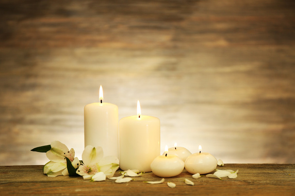 Candles with flowers on wooden background - Photo, Image