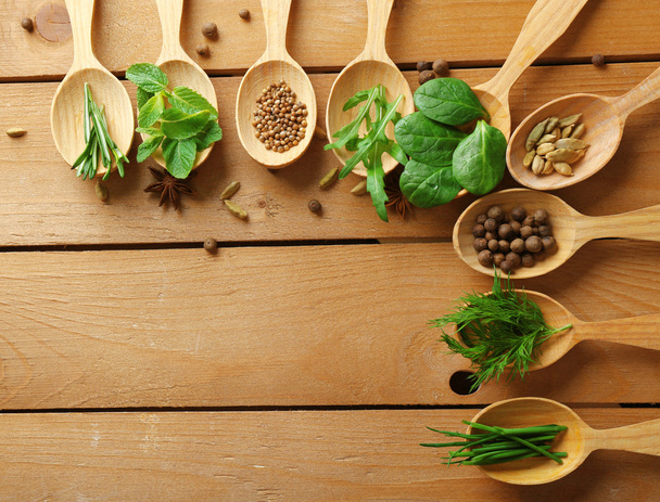 Wooden spoons with fresh herbs - 写真・画像