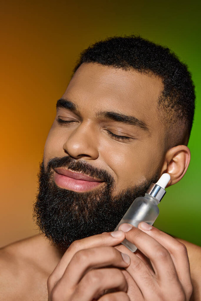 African american handsome man holds serum. - Photo, Image