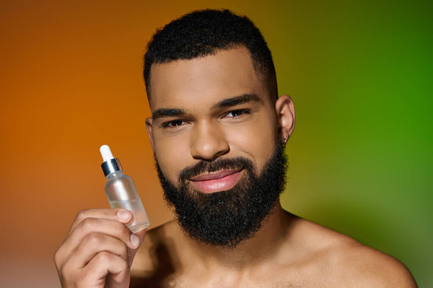 African american bearded man holds serum. - Photo, Image