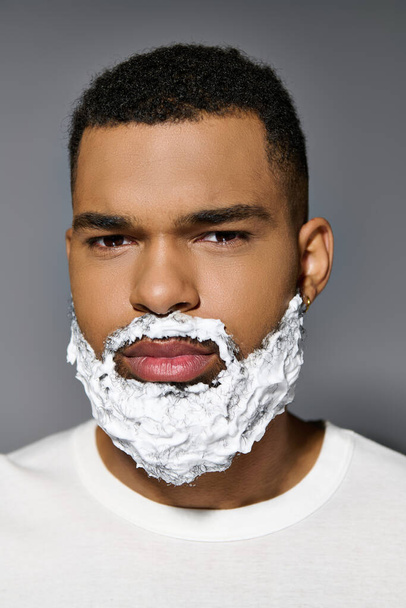 African american young man closely shaves his face as part of a skincare routine. - Photo, Image