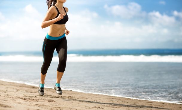 Female running on beach - Фото, изображение