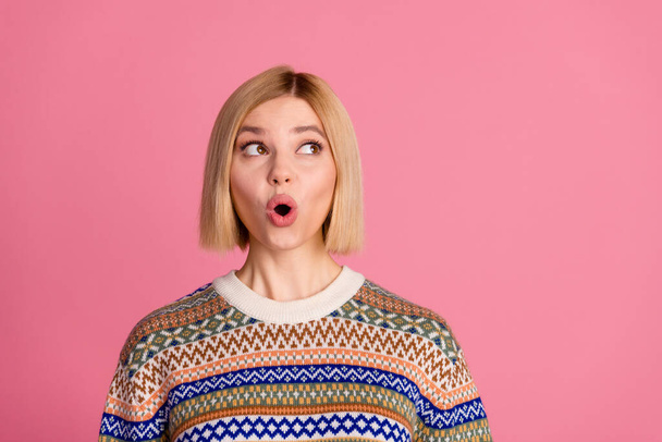 Photo of overjoyed funny girl with bob hairstyle dressed print sweater staring at discount empty space isolated on pink color background. - Foto, Imagen