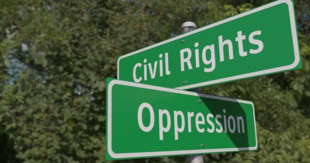 Pan of Civil Rights, Oppression 2 Way Green Road Sign Along The Road. - Кадры, видео