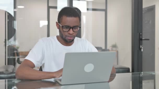 Pulgares hacia arriba por el hombre africano joven usando el ordenador portátil - Metraje, vídeo