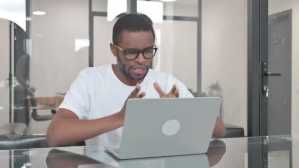 Jeune homme africain faisant du chat vidéo au bureau - Séquence, vidéo