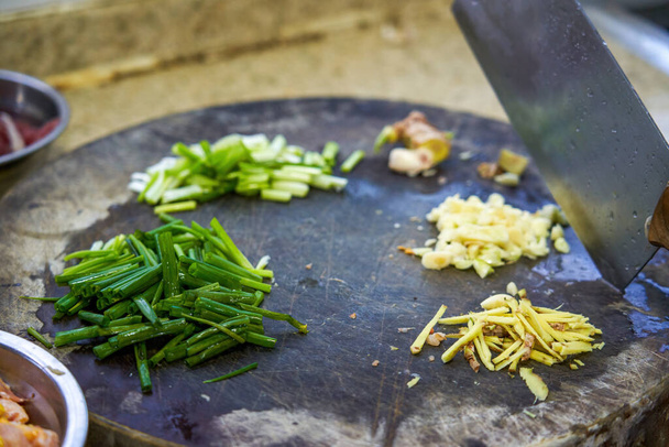 Ingredients for stir-fry prepared on chopping board in Chinese kitchen - Photo, Image