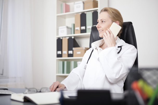 Happy Female Clinician Calling on Mobile Phone - Photo, image