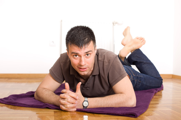 Man lying on the floor on stomach - Photo, Image