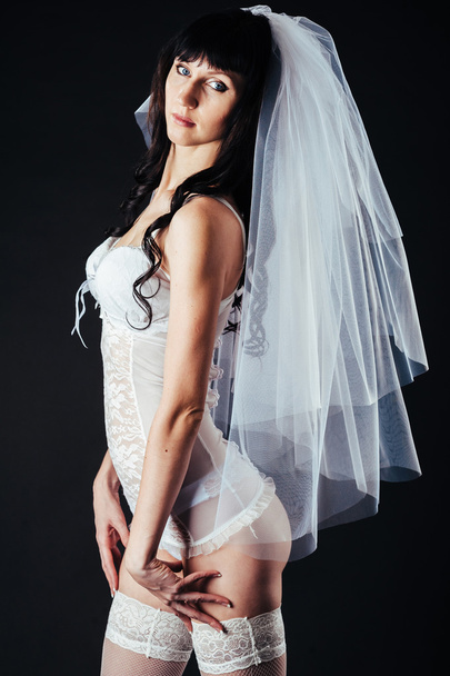 Sexy beautiful nude bride with veil in white erotic lingerie on a black background. beauty portrait of woman - Foto, Imagem